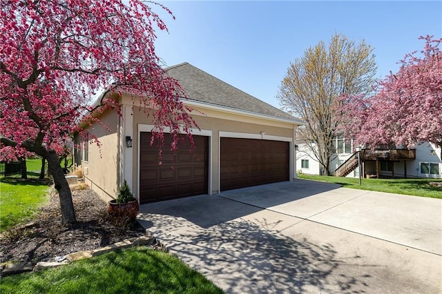 3015 SW 9th Ter, Lees Summit, MO 64081 - view of side of home with a shingled roof, a garage, stairs, stucco siding, and driveway