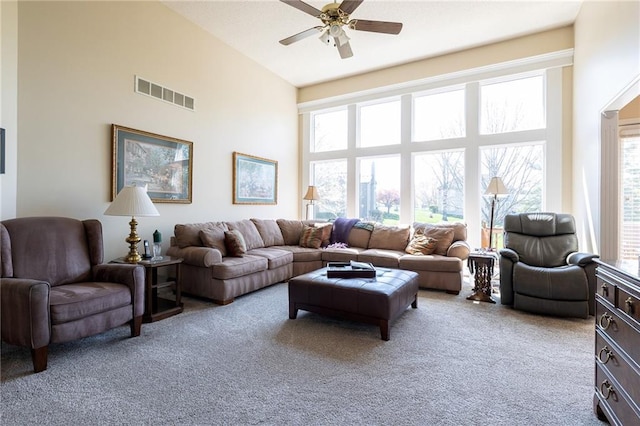 3015 SW 9th Ter, Lees Summit, MO 64081 - carpeted living room with a wealth of natural light, visible vents, a high ceiling, and a ceiling fan