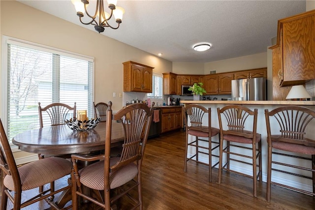 3015 SW 9th Ter, Lees Summit, MO 64081 - dining area with a notable chandelier and dark wood finished floors