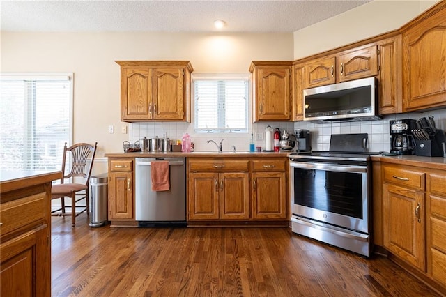 3015 SW 9th Ter, Lees Summit, MO 64081 - kitchen with brown cabinets, a sink, and appliances with stainless steel finishes