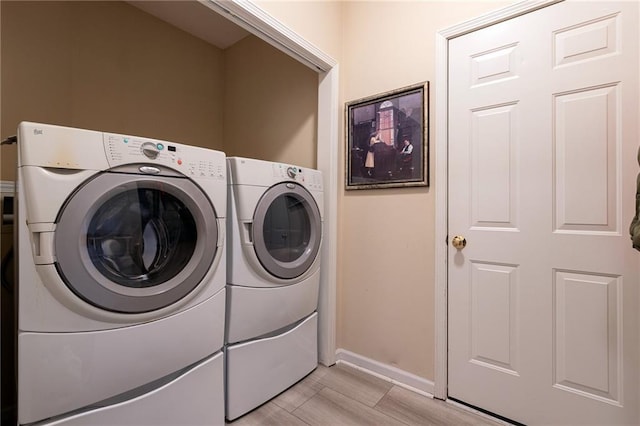 3015 SW 9th Ter, Lees Summit, MO 64081 - laundry area with baseboards, light wood-style floors, separate washer and dryer, and laundry area