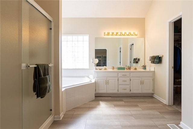 3015 SW 9th Ter, Lees Summit, MO 64081 - bathroom featuring a spacious closet, double vanity, a stall shower, and a garden tub