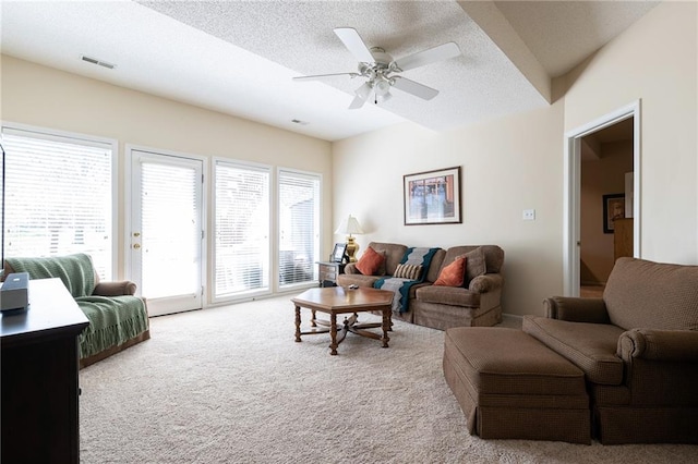 3015 SW 9th Ter, Lees Summit, MO 64081 - living room featuring visible vents, ceiling fan, carpet flooring, and a textured ceiling
