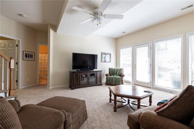 3015 SW 9th Ter, Lees Summit, MO 64081 - living area with visible vents, baseboards, a ceiling fan, stairs, and light colored carpet