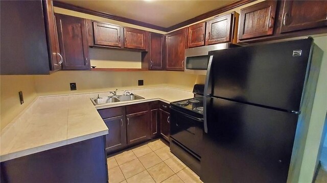 616 E Jackson E, Jackson, Pittsburg, KS 66762 - kitchen with a sink, light countertops, black appliances, and light tile patterned floors