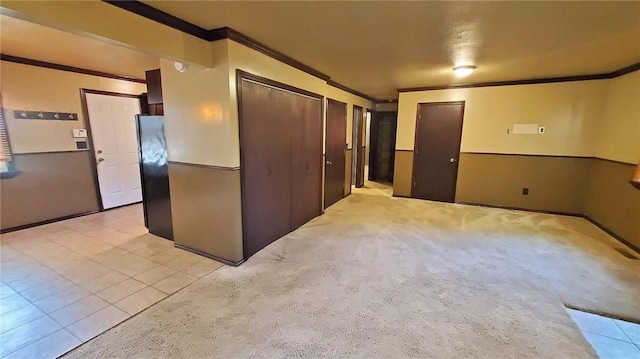 616 E Jackson E, Jackson, Pittsburg, KS 66762 - interior space featuring light carpet, light tile patterned flooring, and ornamental molding