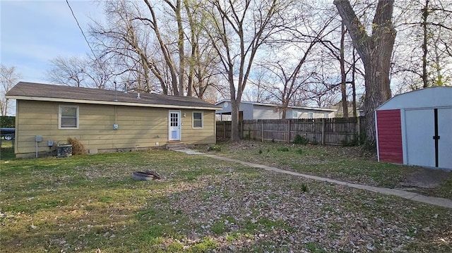 616 E Jackson E, Jackson, Pittsburg, KS 66762 - back of house featuring a lawn, an outbuilding, fence, and a storage unit