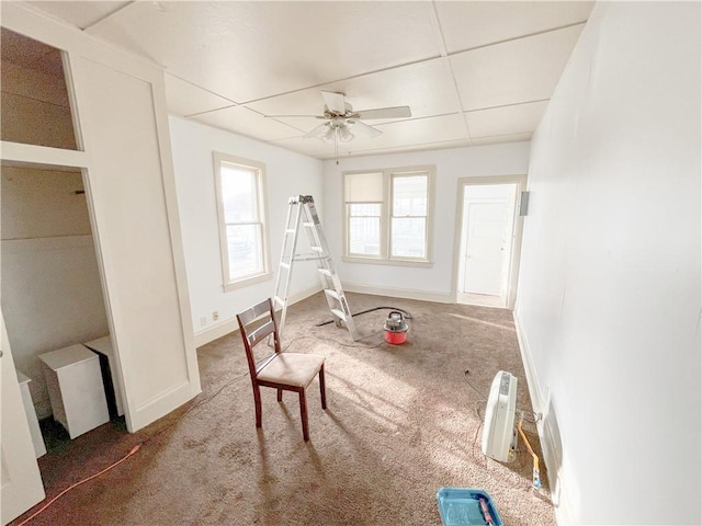 rec room with a ceiling fan, carpet, baseboards, and a paneled ceiling