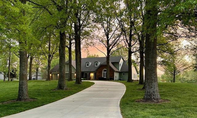 9701 Timber Meadows Dr, Lees Summit, MO 64086 - view of front facade featuring a yard and curved driveway