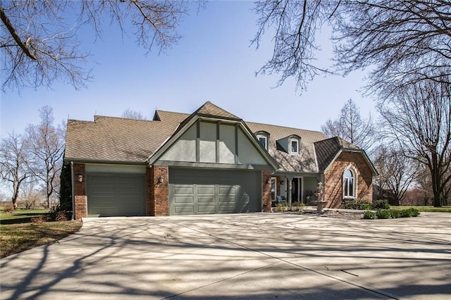 9701 Timber Meadows Dr, Lees Summit, MO 64086 - tudor home with an attached garage, brick siding, and driveway