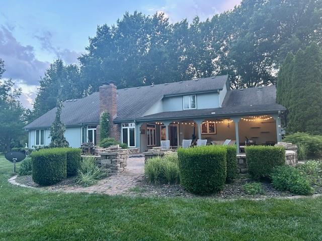 9701 Timber Meadows Dr, Lees Summit, MO 64086 - rear view of house featuring a chimney and a yard