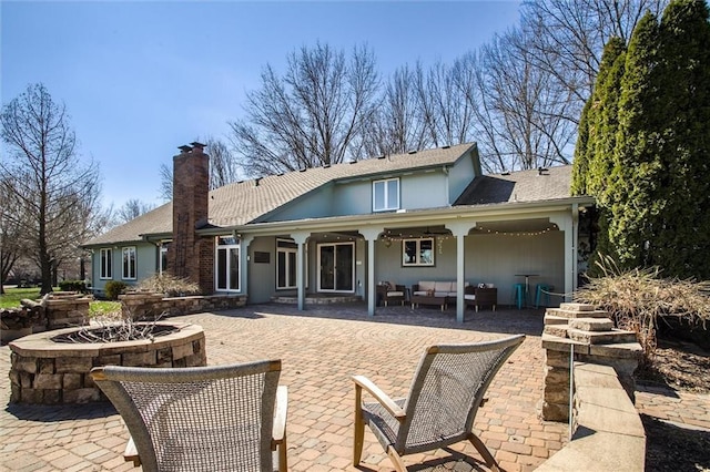 9701 Timber Meadows Dr, Lees Summit, MO 64086 - back of property with a patio area, an outdoor living space, a chimney, and a shingled roof