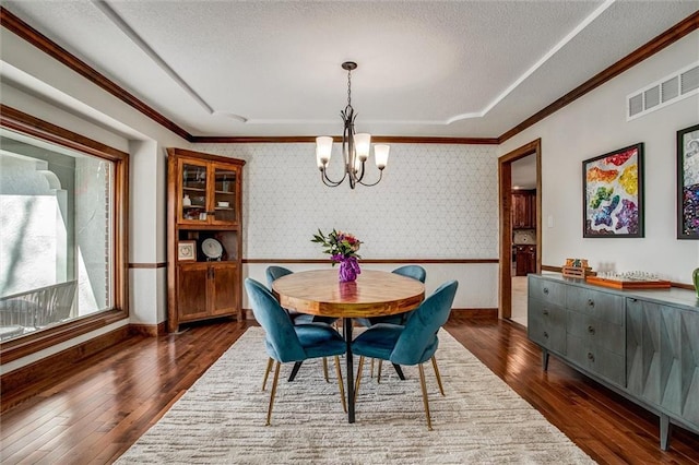 9701 Timber Meadows Dr, Lees Summit, MO 64086 - dining space featuring a chandelier, dark wood-type flooring, crown molding, wallpapered walls, and a textured ceiling
