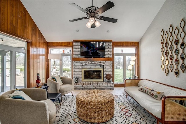 9701 Timber Meadows Dr, Lees Summit, MO 64086 - living area featuring vaulted ceiling, healthy amount of natural light, ceiling fan, wooden walls, and a fireplace