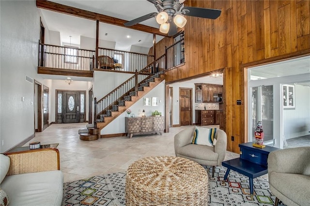 9701 Timber Meadows Dr, Lees Summit, MO 64086 - living area with baseboards, a towering ceiling, stone tile flooring, stairs, and a ceiling fan