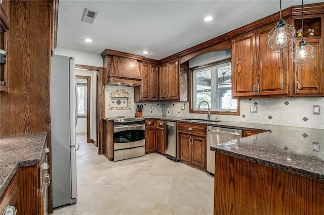 9701 Timber Meadows Dr, Lees Summit, MO 64086 - kitchen with stainless steel appliances, a sink, dark stone countertops, decorative backsplash, and pendant lighting