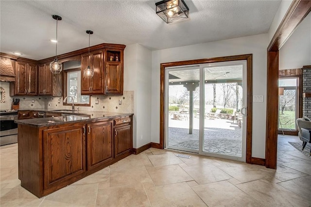 9701 Timber Meadows Dr, Lees Summit, MO 64086 - kitchen featuring stainless steel range with electric cooktop, healthy amount of natural light, baseboards, and a textured ceiling