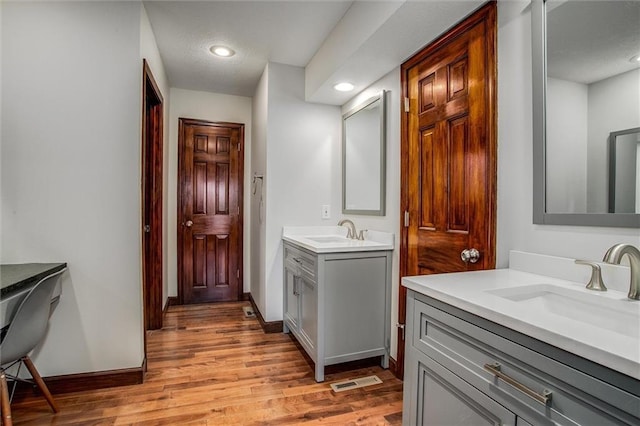 9701 Timber Meadows Dr, Lees Summit, MO 64086 - full bathroom featuring two vanities, wood finished floors, recessed lighting, and baseboards