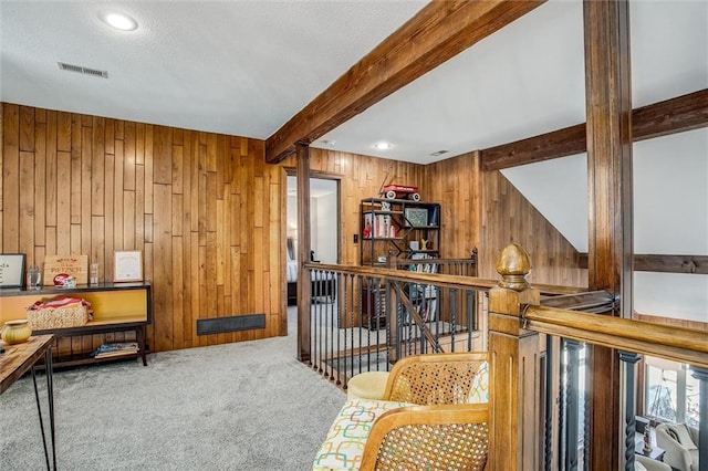 9701 Timber Meadows Dr, Lees Summit, MO 64086 - living area with wood walls, beamed ceiling, carpet flooring, and an upstairs landing