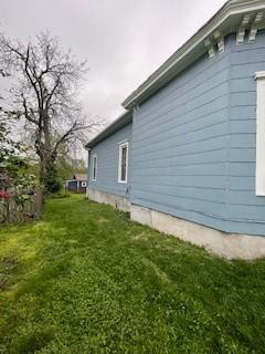 159 S Jewell St, Liberty, MO 64068 - view of property exterior with a yard