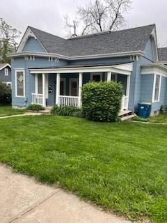 159 S Jewell St, Liberty, MO 64068 - view of front facade featuring covered porch and a front lawn