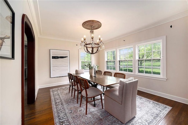 5760 Ward Pkwy, Kansas City, MO 64113 - dining space with an inviting chandelier, arched walkways, baseboards, and crown molding