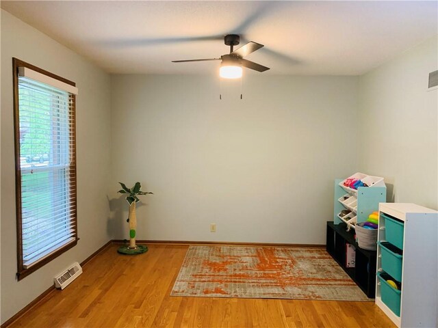 game room with baseboards, ceiling fan, light wood finished floors, and visible vents