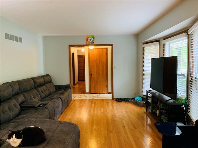 living area featuring visible vents and light wood-style floors