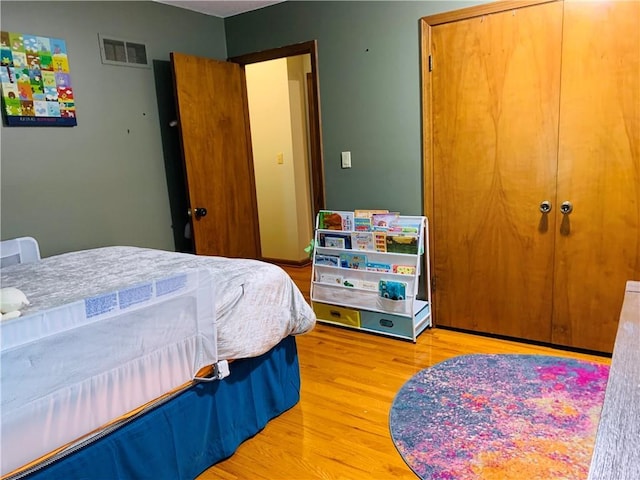 bedroom featuring visible vents and light wood finished floors