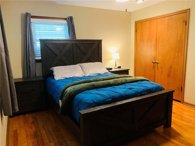 bedroom featuring wood finished floors and a closet