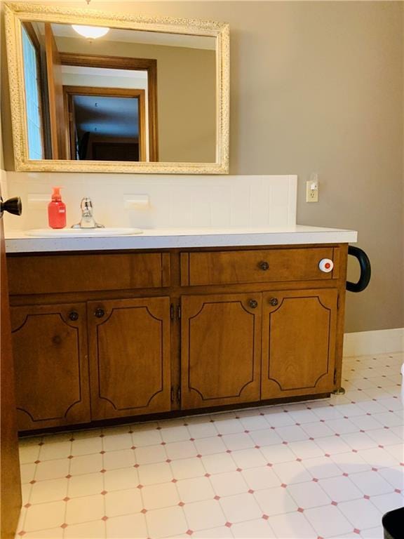 bathroom featuring tile patterned floors, baseboards, and vanity