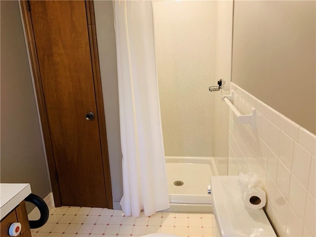 full bath with tile patterned floors and a stall shower