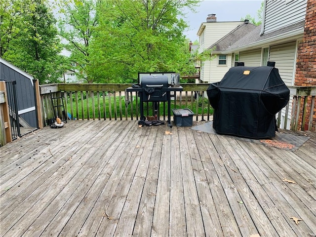 wooden terrace featuring area for grilling