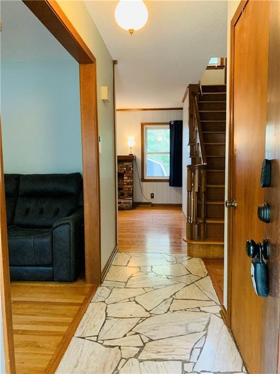 hall with stairway and stone finish flooring