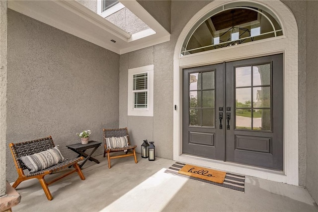 9238 Marion St, Lenexa, KS 66220 - view of exterior entry featuring french doors and stucco siding