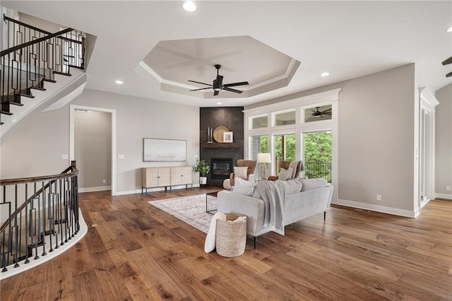 9238 Marion St, Lenexa, KS 66220 - living area with ceiling fan, a raised ceiling, a large fireplace, wood finished floors, and recessed lighting