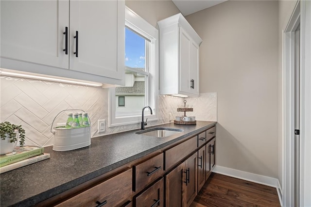 9238 Marion St, Lenexa, KS 66220 - kitchen with a sink, dark countertops, dark wood finished floors, and white cabinets