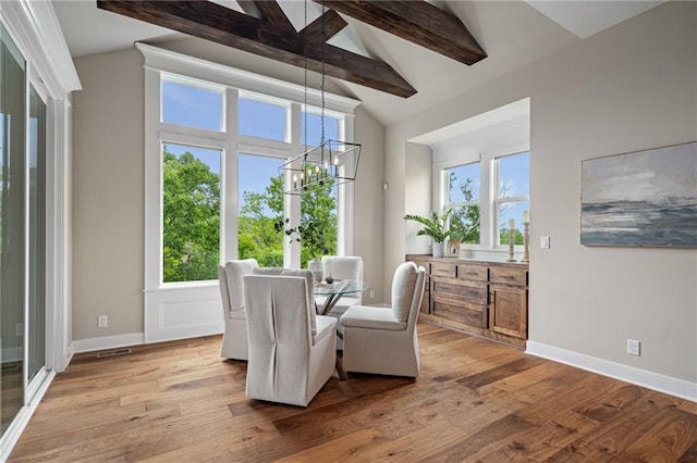 9238 Marion St, Lenexa, KS 66220 - dining space featuring a chandelier, light wood-type flooring, plenty of natural light, and baseboards