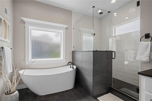 9238 Marion St, Lenexa, KS 66220 - full bath featuring a soaking tub, a stall shower, and tile patterned flooring