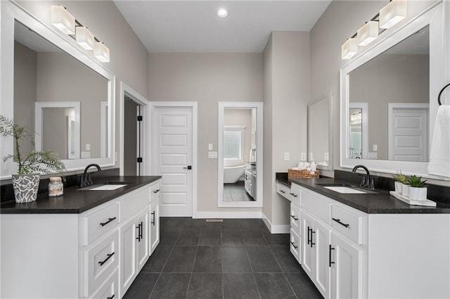 9238 Marion St, Lenexa, KS 66220 - bathroom featuring two vanities, a freestanding tub, baseboards, tile patterned floors, and recessed lighting