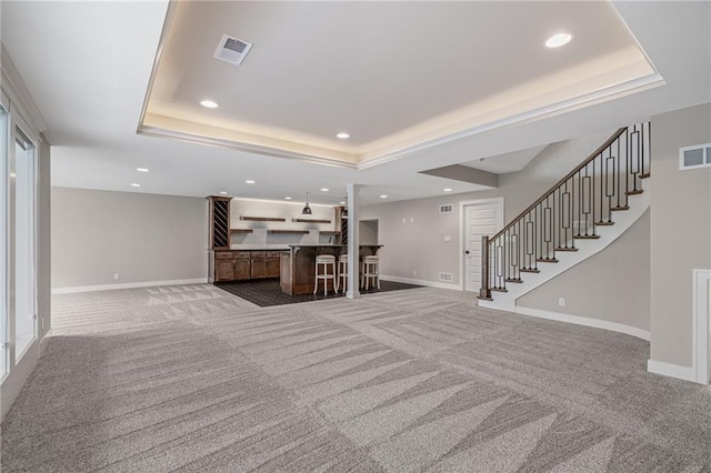 9238 Marion St, Lenexa, KS 66220 - living room with a tray ceiling, carpet flooring, recessed lighting, baseboards, and stairway