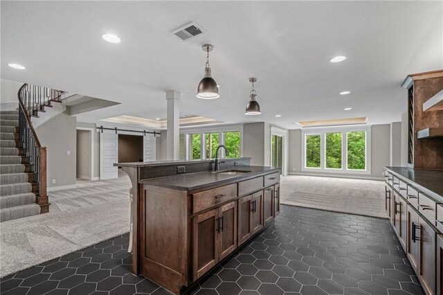 9238 Marion St, Lenexa, KS 66220 - kitchen with open floor plan, a sink, dark colored carpet, a barn door, and recessed lighting