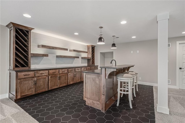 9238 Marion St, Lenexa, KS 66220 - kitchen with open shelves, dark countertops, recessed lighting, a breakfast bar, and decorative light fixtures