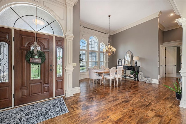 15511 Salem Rd, Excelsior Springs, MO 64024 - foyer entrance featuring a chandelier, dark wood-style flooring, baseboards, ornate columns, and ornamental molding