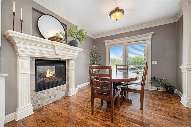 15511 Salem Rd, Excelsior Springs, MO 64024 - dining area with wood finished floors, a multi sided fireplace, baseboards, and crown molding