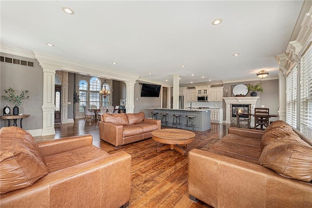 15511 Salem Rd, Excelsior Springs, MO 64024 - living area featuring ornate columns, ornamental molding, recessed lighting, wood finished floors, and a glass covered fireplace