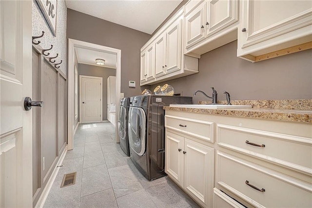 15511 Salem Rd, Excelsior Springs, MO 64024 - washroom featuring cabinet space, washing machine and clothes dryer, and light tile patterned floors