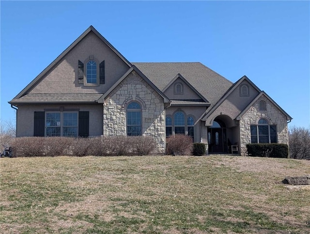 15511 Salem Rd, Excelsior Springs, MO 64024 - french country home with stone siding, a front lawn, and stucco siding
