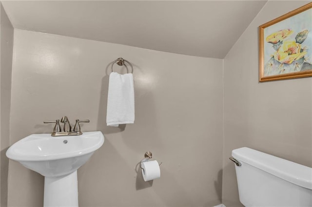 half bathroom with a sink and toilet