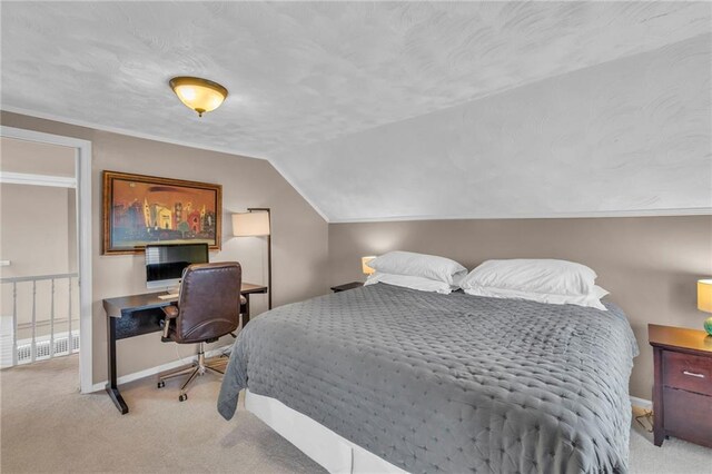 bedroom with baseboards, carpet floors, and lofted ceiling